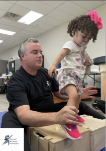 Image of specialist helping child using Dynamic Movement Intervention methods